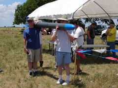 large rocket being carried by its crew